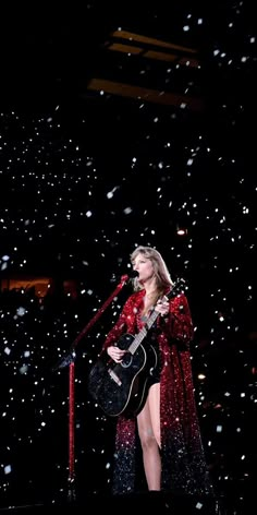 taylor swift performs on stage in the snow