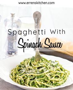 spaghetti with spinach sauce on a white plate