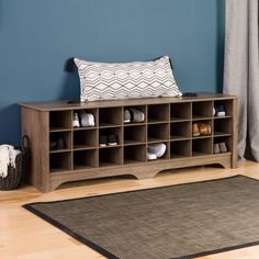 a living room with blue walls and wooden shelves on the floor next to a rug