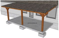 an outdoor covered patio with concrete flooring and wood posts on the side of it