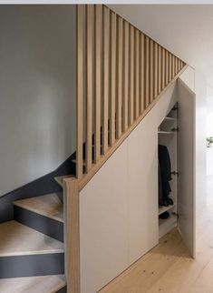 the stairs are made of wood and have black stripes on them, along with white walls