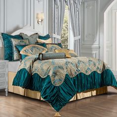 a bed with blue and gold comforters in a room