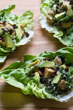 three lettuce wraps with avocado, nuts and crumbled cheese