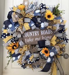 a wreath that says country roads take me home with sunflowers and ribbons on it