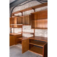 an empty room with wooden shelves and shelving