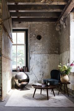 two chairs and a table in an old room