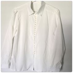 White Buttons Down Dress Shirt In White Color And Multiple Buttons, Chiffon Material. Never Worn Still New Condition. Formal Button-up Blouse With Pearl Buttons, Elegant Button-up Tops With Pearl Buttons, Elegant Button-up Blouse With Pearl Buttons, Pearl Button-up Blouse For Work, Workwear Blouse With Pearl Buttons, Classic Blouse With Pearl Buttons, Spring Formal Blouse With Pearl Buttons, Chic White Blouse With Covered Buttons, Classic Formal Blouse With Pearl Buttons