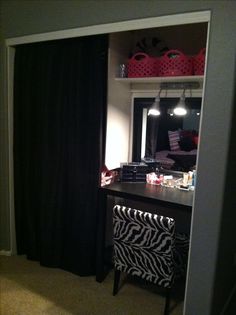 a bedroom with a zebra print chair in front of a mirror and closet door open