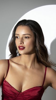 a woman in a red dress posing for the camera