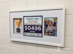 two framed photos with the same person's name and their race bib number