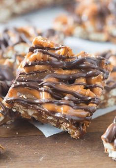 chocolate and caramel pretzel bars are stacked on top of each other, ready to be eaten