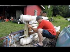 a man is working on pipes in the back of a truck