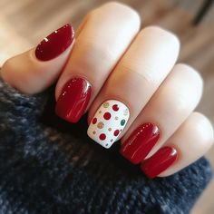 Celebrate the holiday season with Artistic Wonderland Nails! This festive design features perfectly trimmed nails, with four nails in glossy red and the center nail adorned with a vibrant mix of red, green, and gold dots. The clean, glossy finish adds extra shine and elegance, making these Christmas nails perfect for spreading holiday cheer. Bold, playful, and chic—this design will bring joy and sparkle to your festive look!  #ArtisticWonderlandNails #ChristmasNails #FestiveNailArt #HolidayNails #DotNailArt #RedChristmasNails #JoyfulNails #GlossyNailDesign #ChristmasNailInspo Christmas Nails Inspiration Red, Christmas Dot Nail Art, Christmas Nails Dots, Christmas Dot Nails, Christmas Nail Designs Dip Powder, Polka Dot Christmas Nails, December Dip Nail Ideas, Christmas Polka Dot Nails, Christmas Nails Toes