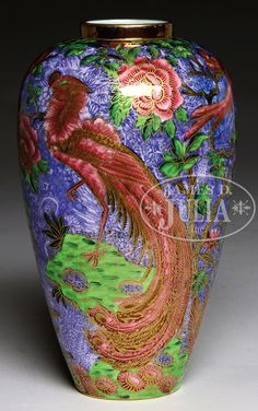 a colorful vase with a bird and flowers on it