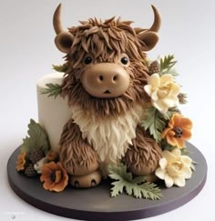 there is a cake decorated like a cow with flowers on it's head and horns