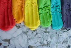 five different colored ice creams lined up in a row on top of each other