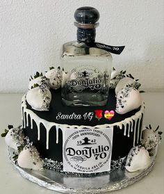 a black and white cake with an ice cream covered bottle on the top that says donjuro