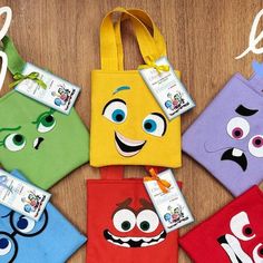 four bags with different colored faces on them