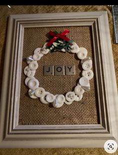 a frame with buttons in the shape of a wreath