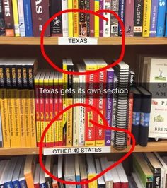 a book shelf filled with lots of books and two red circles on top of them