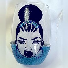 a wine glass with an image of a woman's face painted on the side