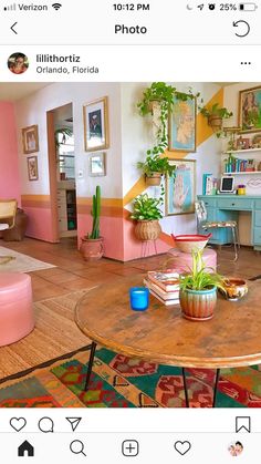 a living room filled with lots of furniture and colorful decor on top of wooden tables