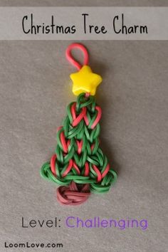 a christmas tree charm made out of paper and colored yarn with a star on top