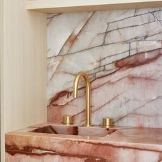 a marble sink and faucet in a bathroom