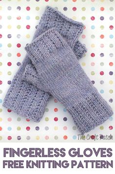 two gray knitted mittens sitting on top of a polka dot covered tablecloth