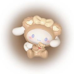 a brown and white teddy bear sitting on top of a bone shaped object with eyes closed