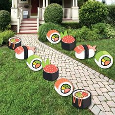 sushi party decorations on the lawn in front of a house