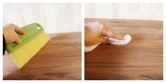 a person cleaning a wooden table with a brush and sponge on it, while another hand is using a dust mop to clean the wood