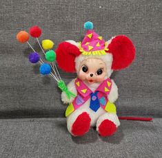 a small stuffed animal with lots of pom poms