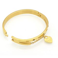 Our most wanted Forever Love Bangles are the perfect gift choice for a loved one or a special self-treat. It is complete with a beautiful Roman Numeric design, three crystal gems & an eye-catching dangling heart. Description: Material: Stainless Steel + Cubic Zirconia Stones Gold Bangle: 18K Gold Plated Perimeter: 18cm Non-tarnish Can be personalised The dangling heart reads: 'Please return to Forever Love New York 520' Frequent Q&A's "Can I wear it in the shower?" Yes, this item can be exposed Rose Gold Stainless Steel Promise Jewelry, Valentine's Day Stainless Steel Bangle, Luxury Metal Jewelry For Valentine's Day, Love Bangle, Customizable Jewelry, Romantic Design, Hanging Hearts, Colored Gems, Gold Bangle