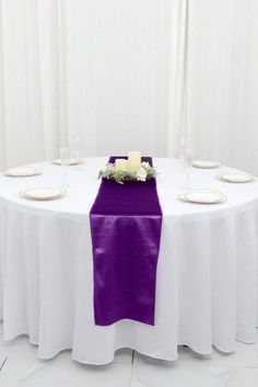 the table is set with white plates and place settings for two people to sit at