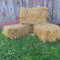 three hay bales stacked on top of each other in the grass