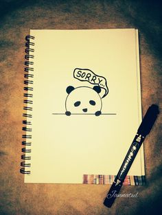 an open notebook with a panda bear drawn on it and a pen next to it