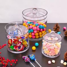 three glass containers filled with candy and candies