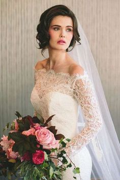 a woman in a wedding dress holding a bouquet