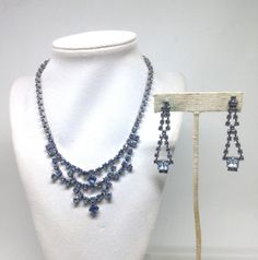 "Vintage Estate Blue Rhinestone AB Waterfall Necklace And Dangle Earrings  This lovely piece can be worn on any occasion and is absolutely beautiful in the light, both inside and out, the perfect gift for anyone who loves vintage jewelry.  - Measures Approx.  - Each order comes shipped in a small drawstring pouch, all ready for     gifting. -If you are wanting to have this mailed as a gift to a special someone,  please write their address in the note section, otherwise it will be  mailed to you. -If you would like to add a special typed note added to the order, please  type that into my \"note to seller\" and we can add that special  message. Thank You so much for visiting Paradise Vintage Jewelry Shop Diana Waggoner 1630@011" Small Drawstring Pouch, Waterfall Necklace, Dance Shirts, Lipstick Holder, Drawstring Pouch, Stunning Necklace, Blue Rhinestones, 1960s Vintage, Earrings Set