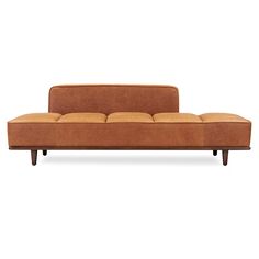 a brown couch sitting on top of a white floor