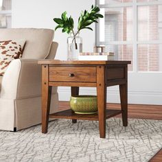 a living room scene with focus on the end table and sofa in the foreground