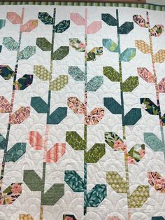 a close up of a quilt with flowers on it