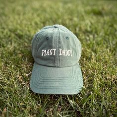 Introducing the cozy and stylish Plant Daddy hat from Plant Scouts - your one-stop-shop for all things plants. This hat is not only a functional accessory to protect you from the sun while you care for your indoor oasis, but it also serves as a reminder of your love and dedication to your beloved plants. The playful "Plant Daddy" text on the hat brings a smile to your face and lets others know that you're proud of your green thumb. So, whether you're relaxing in your backyard or tending to your Comfortable Curved Brim Hat, Comfortable One Size Fits Most Baseball Cap, Eco-friendly Curved Brim Hat For Outdoor, Eco-friendly Curved Brim Outdoor Hat, Outdoor Brimmed Dad Hat, Comfortable Outdoor Hat With Curved Brim, Green Brimmed Baseball Cap, Comfortable Curved Brim Outdoor Hat, Comfortable Curved Brim Hat For Outdoor