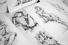 some drawings are laying on top of each other in this black and white photo,