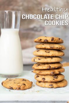 chocolate chip cookies stacked on top of each other next to a glass of milk