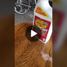 a bottle of krud kutter glue sitting on top of a wooden table