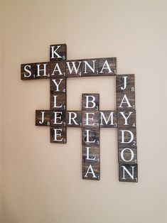 a cross made out of wooden letters on a wall