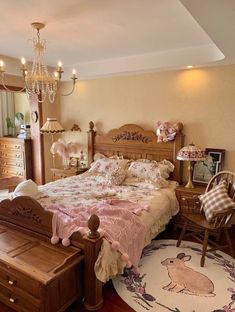 a bed room with a neatly made bed and a chandelier