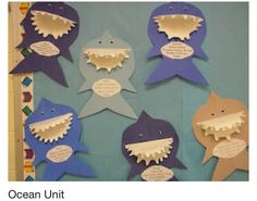 some paper cut out sharks with words on them